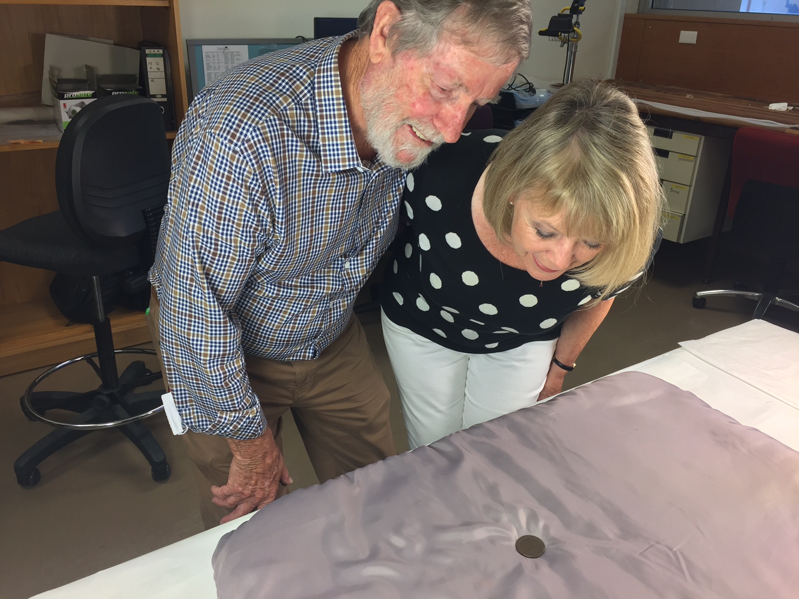 Brian and Beverley Oakley examine the convict token.